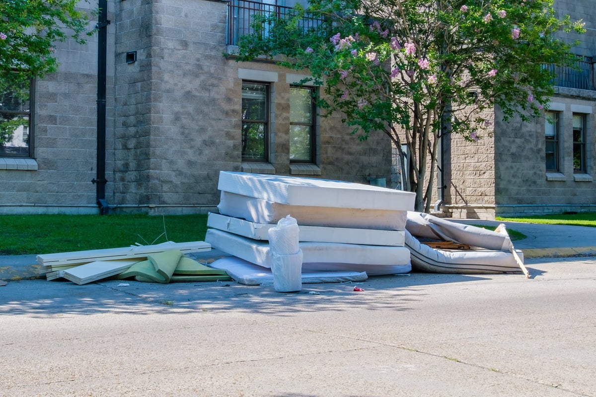 Discarded Bedding on Sidewalk near College Dormitories in New Orleans, Louisiana, USA
